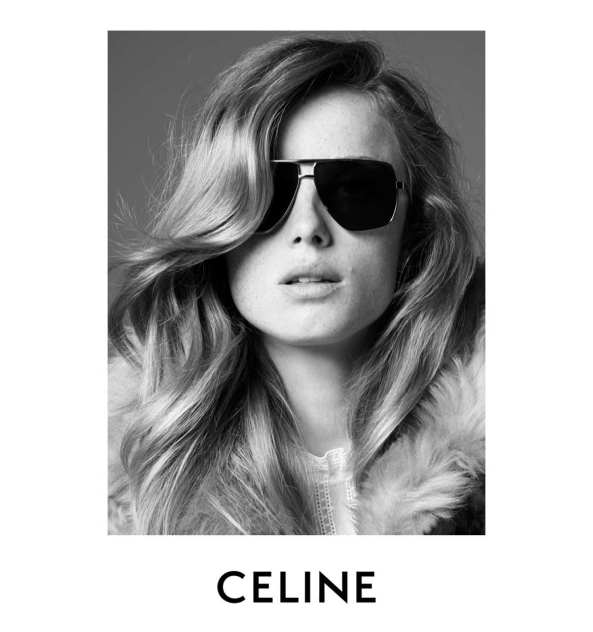 A long-haired woman wearing CELINE sunglasses that feature a geometric double-bridged silhouette